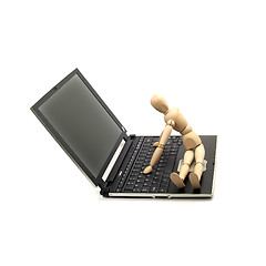 Image showing wood mannequin and laptop