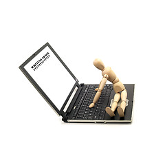 Image showing wood mannequin and laptop