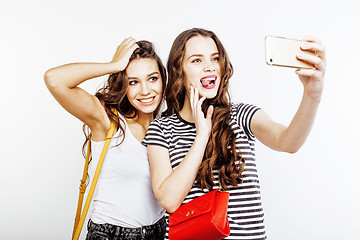 Image showing two best friends teenage girls together having fun, posing emotional on white background, besties happy smiling, making selfie, lifestyle people concept