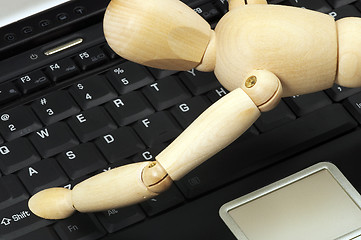 Image showing wood mannequin and laptop