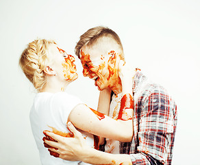 Image showing young pretty couple, lifestyle people concept: girlfriend and boyfriend cooking together, having fun, making mess isolated on white background