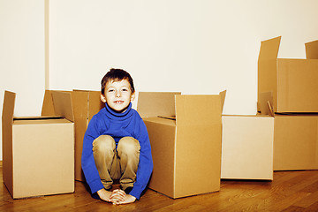 Image showing little cute boy in empty room, remoove to new house. home alone, lifestyle people concept