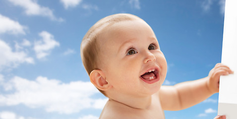 Image showing happy little baby boy or girl looking up