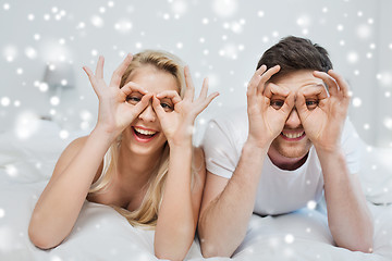 Image showing happy couple lying in bed at home