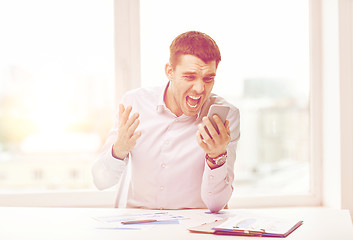 Image showing close up of businessman with smartphone