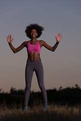 Image showing black woman is doing stretching exercise relaxing and warm up