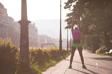 Image showing Black woman doing warming up and stretching