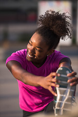 Image showing African American woman doing warming up and stretching