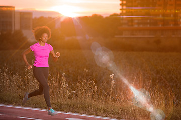 Image showing a young African American woman jogging outdoors