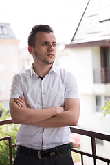 Image showing man standing at balcony