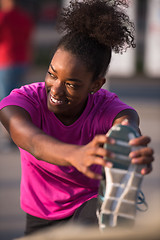 Image showing African American woman doing warming up and stretching