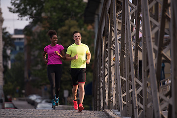 Image showing multiethnic couple jogging in the city