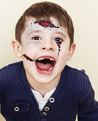 Image showing little cute boy with facepaint like zombie apocalypse at hallowe