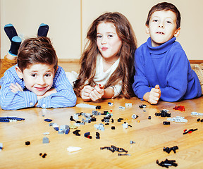 Image showing funny cute children playing lego at home, boys and girl smiling, first education role lifestyle