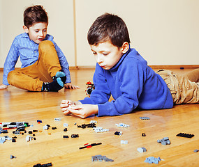 Image showing funny cute children playing lego at home, boys and girl smiling, first education role lifestyle