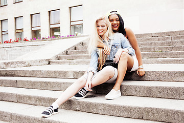 Image showing Two teenage girls infront of university building smiling, having