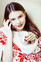 Image showing young pretty brunette girl in Christmas ornament blanket getting warm on cold winter, freshness beauty concept, lifestyle people