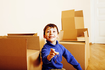 Image showing little cute boy in empty room, remoove to new house. home alone, lifestyle people concept