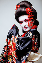 Image showing young pretty geisha in kimono on white background