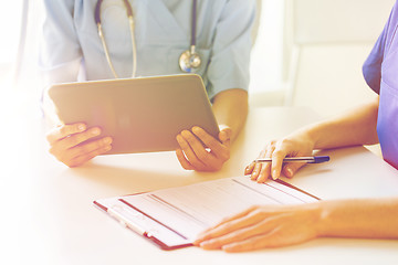 Image showing close up of doctors with tablet pc at hospital