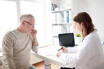 Image showing old man and doctor with prescription at hospital