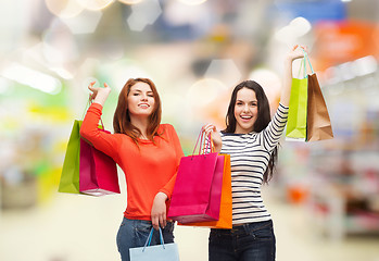 Image showing teenage girls with shopping bags and credit card