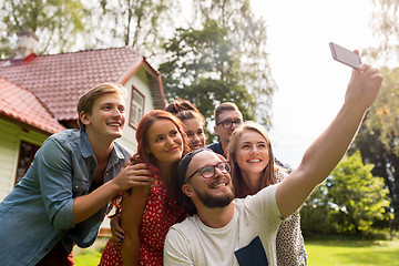 Image showing friends taking selfie at party in summer garden