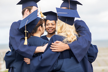 Image showing happy students or bachelors hugging