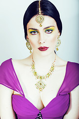 Image showing young pretty caucasian woman like indian in ethnic jewelry close up on white, bridal makeup
