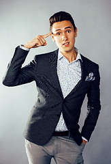 Image showing young pretty business man standing on white background, modern hairstyle, posing emotional, lifestyle people concept