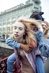 Image showing cute young couple of teenagers girlfriends having fun, traveling europe, modern fashion citylife, lifestyle people concept close up