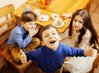 Image showing little cute boys eating dessert on wooden kitchen. home interior. smiling adorable friendship together forever friends, lifestyle people concept