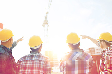 Image showing group of builders in hardhats at construction site