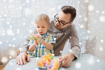 Image showing father and son playing with ball clay at home