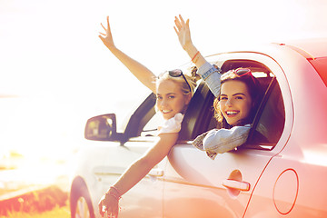 Image showing happy teenage girls or women in car at seaside