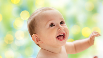 Image showing happy little baby boy or girl looking up