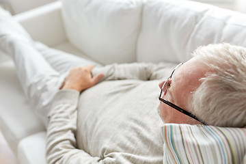 Image showing close up of senior man lying on sofa