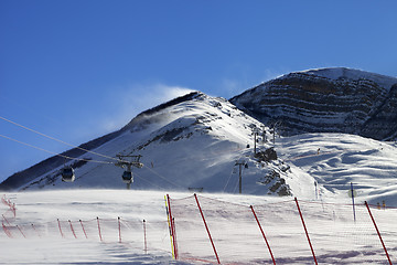 Image showing Gondola lift on ski resort at windy winter day