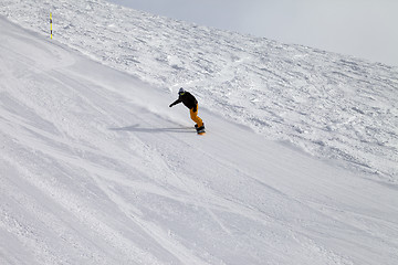 Image showing Ski slope and snowboarder at winter cold day