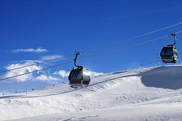 Image showing Gondola lifts on ski resort at sun wind day