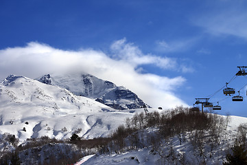 Image showing Ski-lift, off-piste slope and mountain in clouds