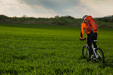 Image showing Man Cyclist with bike on sunset