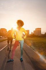 Image showing Portrait of sporty young african american woman running outdoors