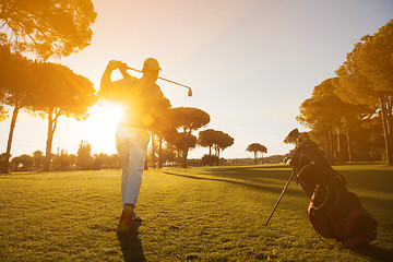 Image showing golf player hitting shot with club