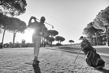 Image showing golf player hitting shot with club