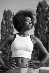 Image showing Portrait of sporty young african american woman running outdoors