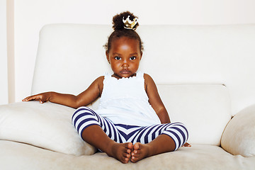 Image showing little pretty african american girl sitting in white chair weari