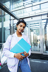 Image showing young cute indian girl at university building sitting on stairs 