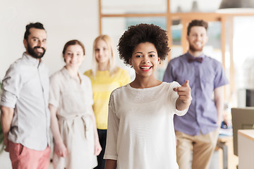 Image showing woman pointing to you over creative office team