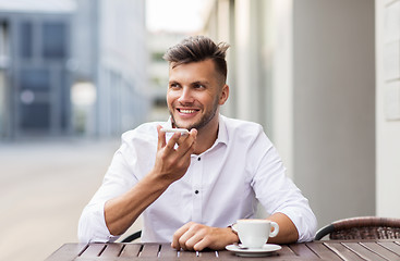 Image showing man with coffee and smartphone at city cafe